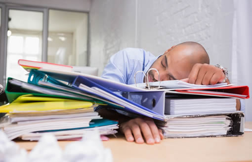 Exhausted from mountains of paperwork